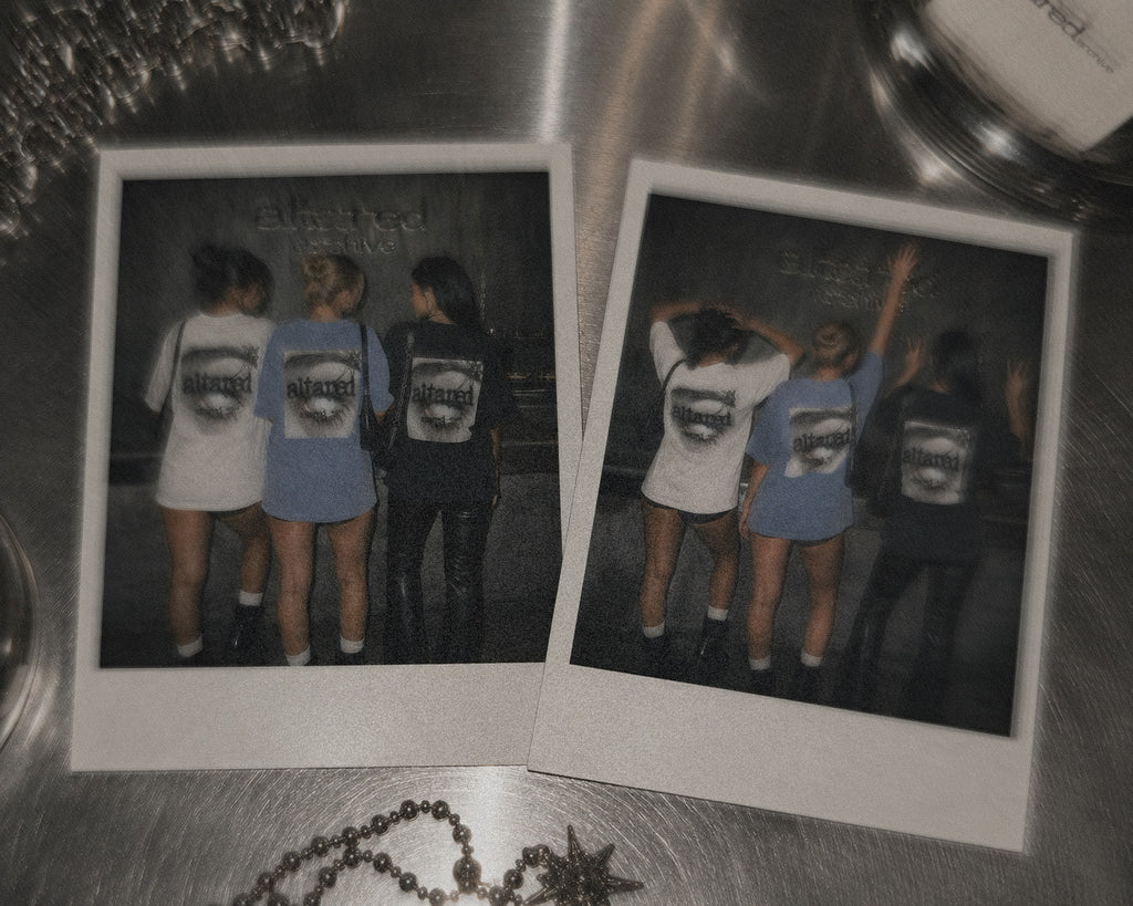 Two Polaroid-style photos showing a group of three women from behind wearing matching graphic t shirts with the "ALTARED STATE" GRAPHIC printed on the back, displayed on a metallic surfacE